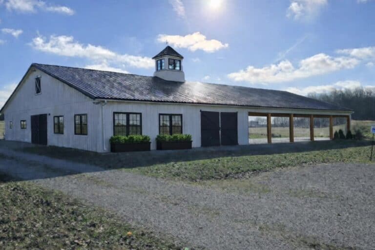 The white barn with cupola and open field at Highland Oaks Weddings and Events in Palmyra, Indiana