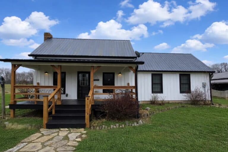 The white farmhouse and open lawn at Highland Oaks Weddings and Events in Palmyra, Indiana, with room for kids to play