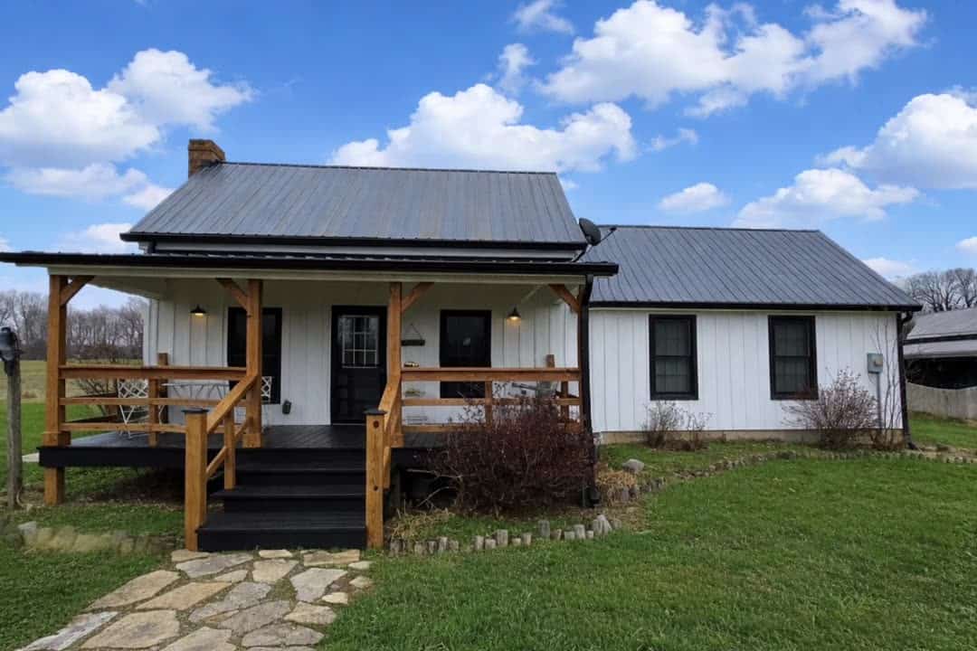 The white farmhouse and open lawn at Highland Oaks Weddings and Events in Palmyra, Indiana, with room for kids to play