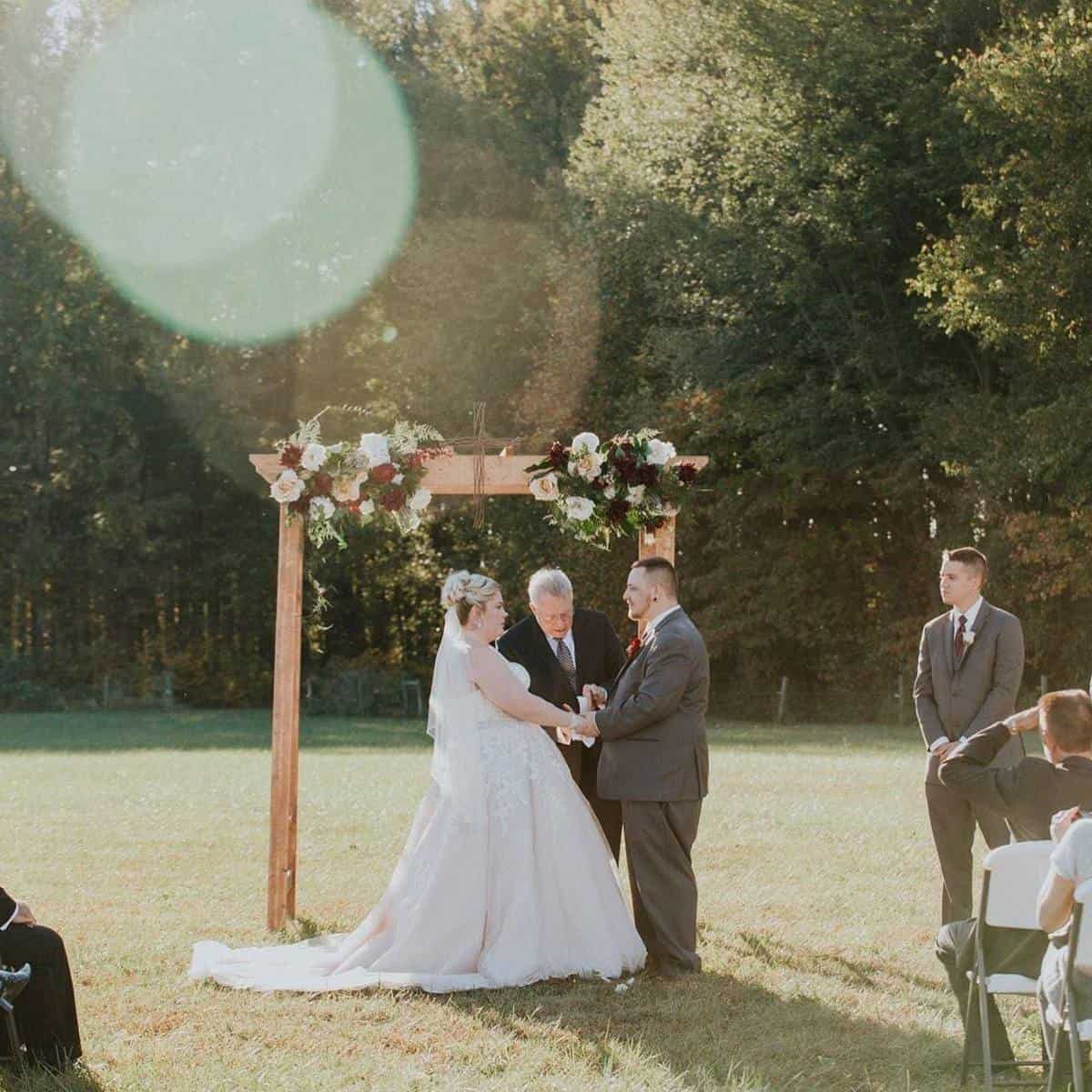 Outdoor wedding ceremony on the open lawn at Highland Oaks in Palmyra, Indiana
