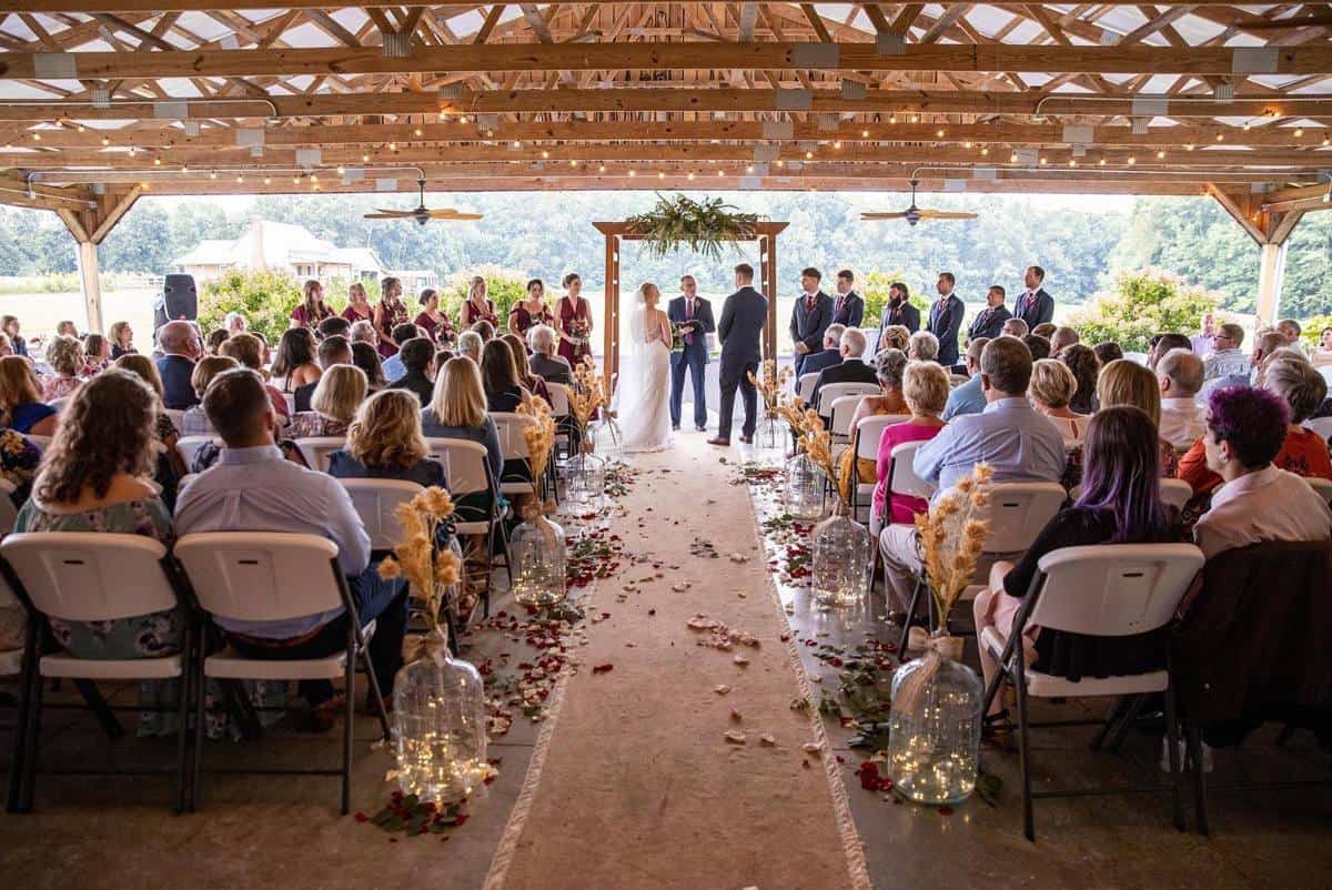 Wedding ceremony under the covered barn at Highland Oaks, Indiana