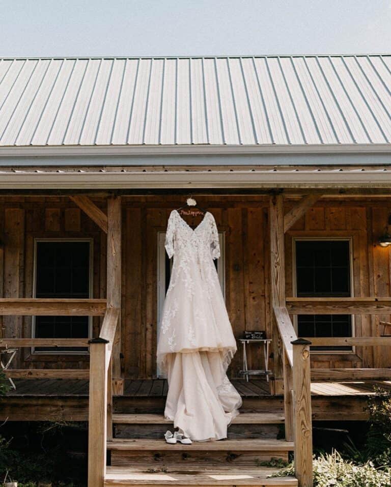 Wedding dress hanging on the front porch of the cottage at Highland Oaks in Palmyra, Indiana
