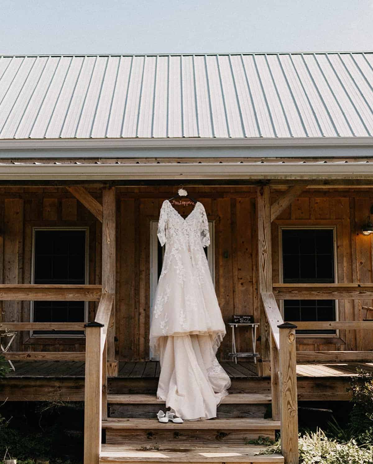 Wedding dress hanging on the front porch of the cottage at Highland Oaks in Palmyra, Indiana